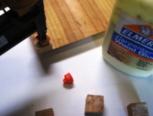 Gluing and nailing the feet onto the base
